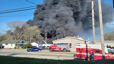 Smoke rises from an industrial fire, Tuesday, April 11, 2023, at 358 NW F Street, in Richmond, Ind.