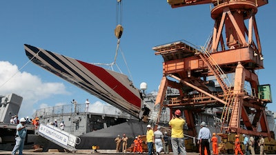 Workers unloading debris, belonging to crashed Air France flight AF447, from the Brazilian Navy's Constitution Frigate in the port of Recife, northeast of Brazil, Sunday, June 14, 2009. A French court is ruling Monday April 17, 2023 on whether Airbus and Air France are guilty of manslaughter over the 2009 crash of Flight 447 en route from Rio to Paris, which killed 228 people and led to lasting changes in aircraft safety measures.