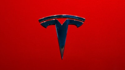 The logo of Tesla model 3 is seen at the Auto show on Oct. 3, 2018, in Paris.